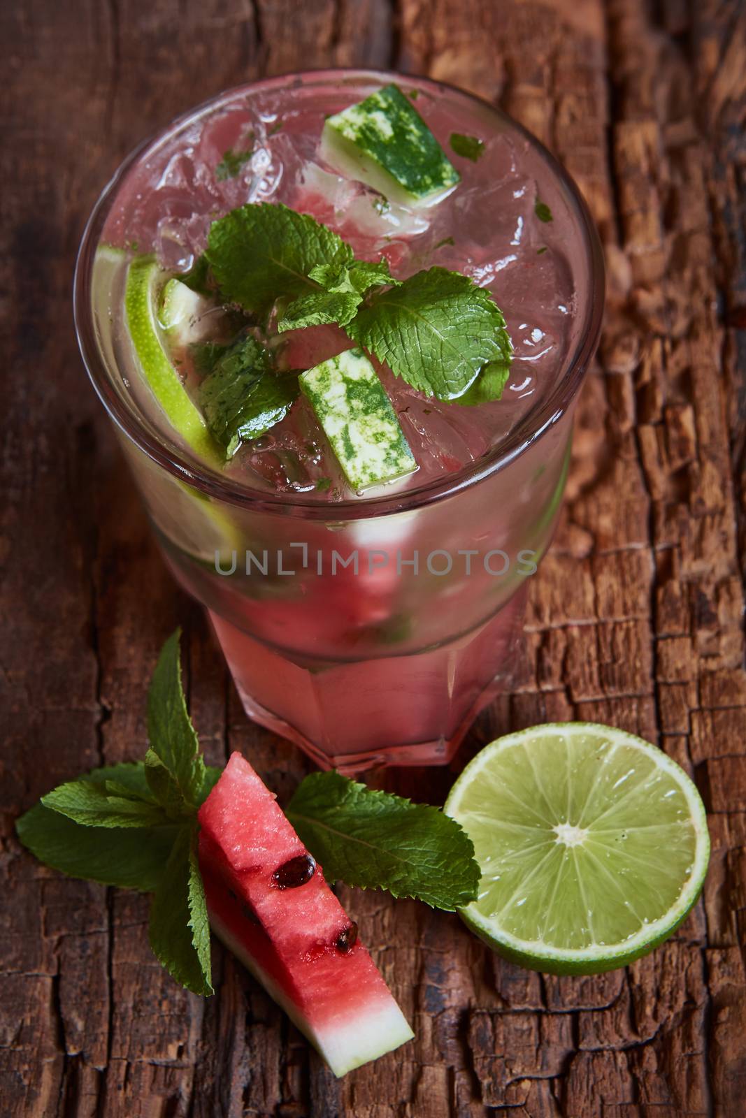 Homemade watermelon lemonade with mint and lime in glasses and slices of watermelon