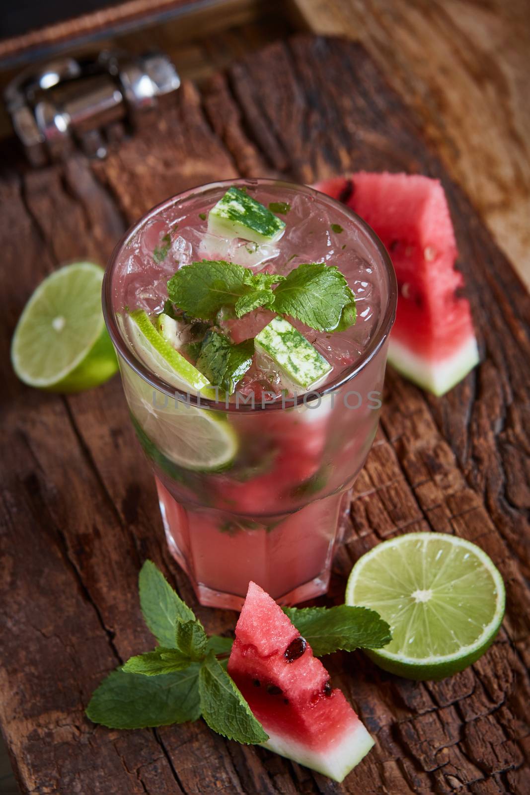 Homemade watermelon lemonade with mint and lime in glasses and slices of watermelon