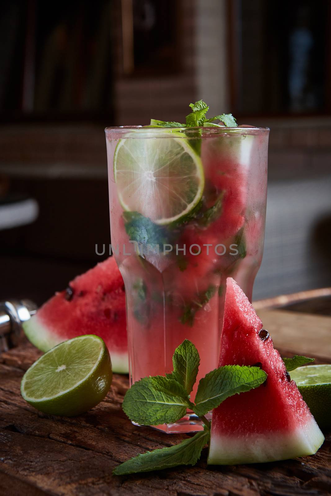 Homemade watermelon lemonade with mint and lime in glasses and slices of watermelon