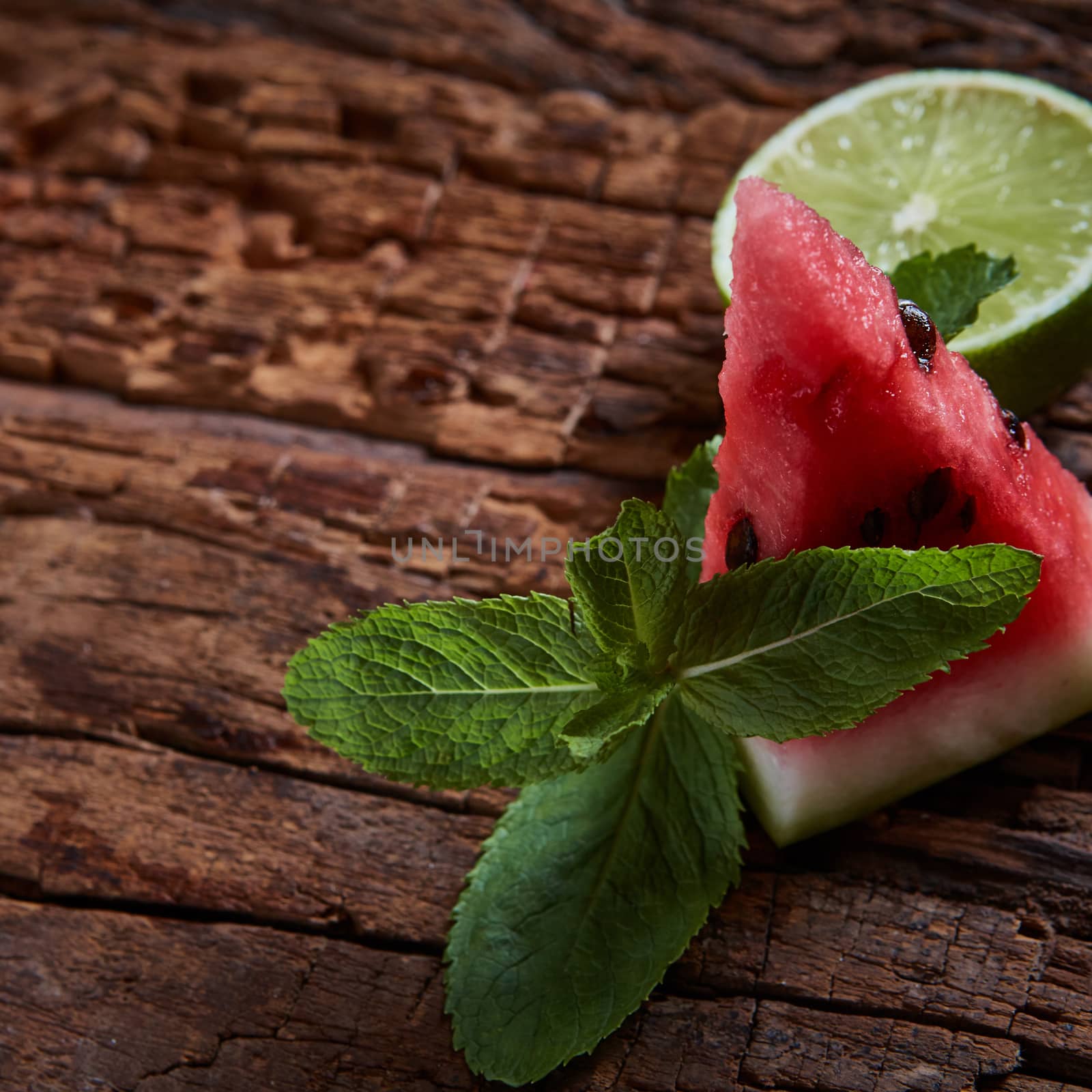 Watermelon, mint and lime with copy space on the wooden background