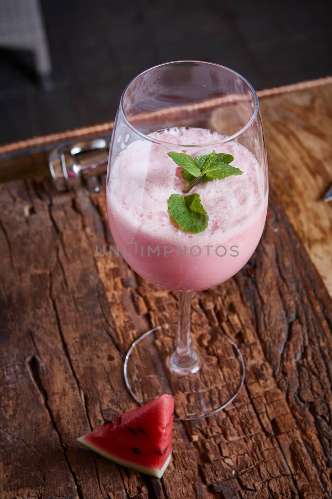 Healthy watermelon and melon smoothie with copy space on a wood background