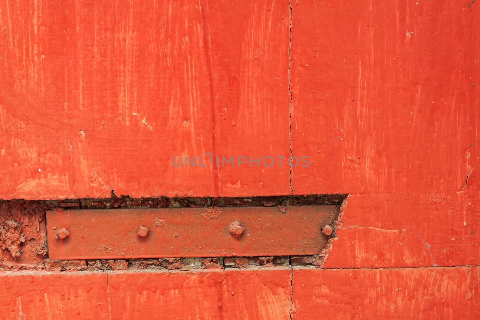 Rusty hinge on red door by kritsada1992