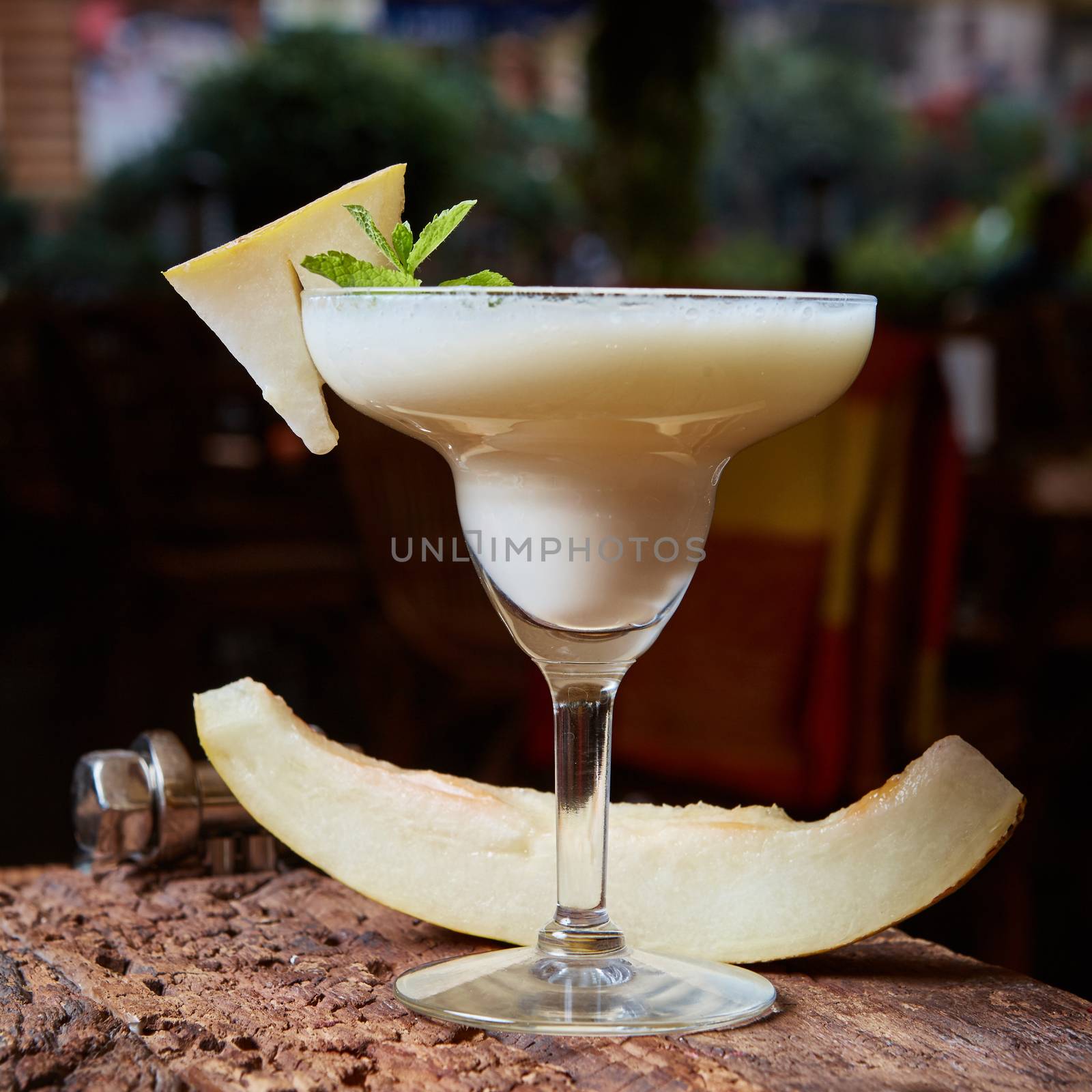 margarita melon cocktail with copy space on wooden background. 