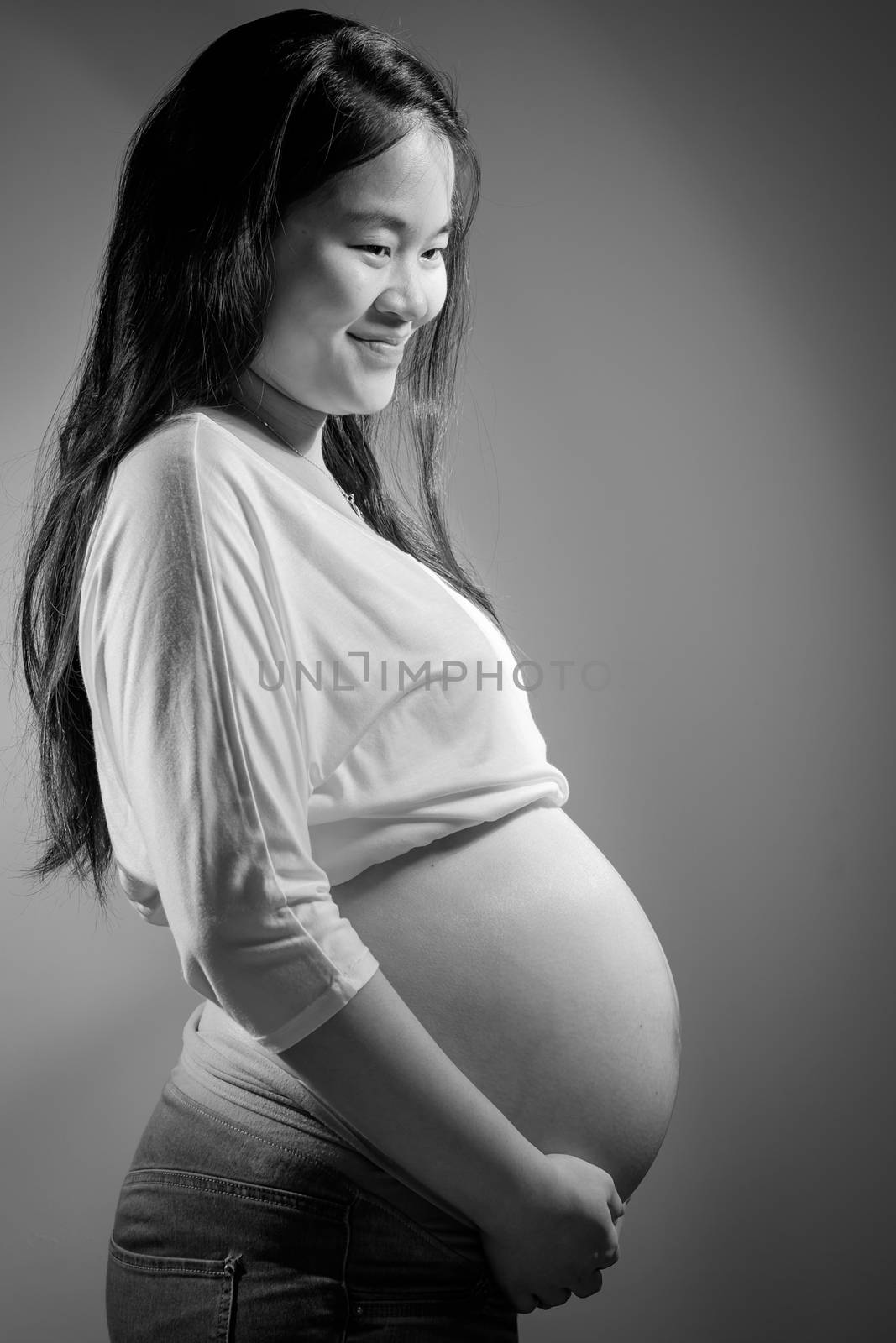 Asian pregnant woman in studio on white background by zneb076