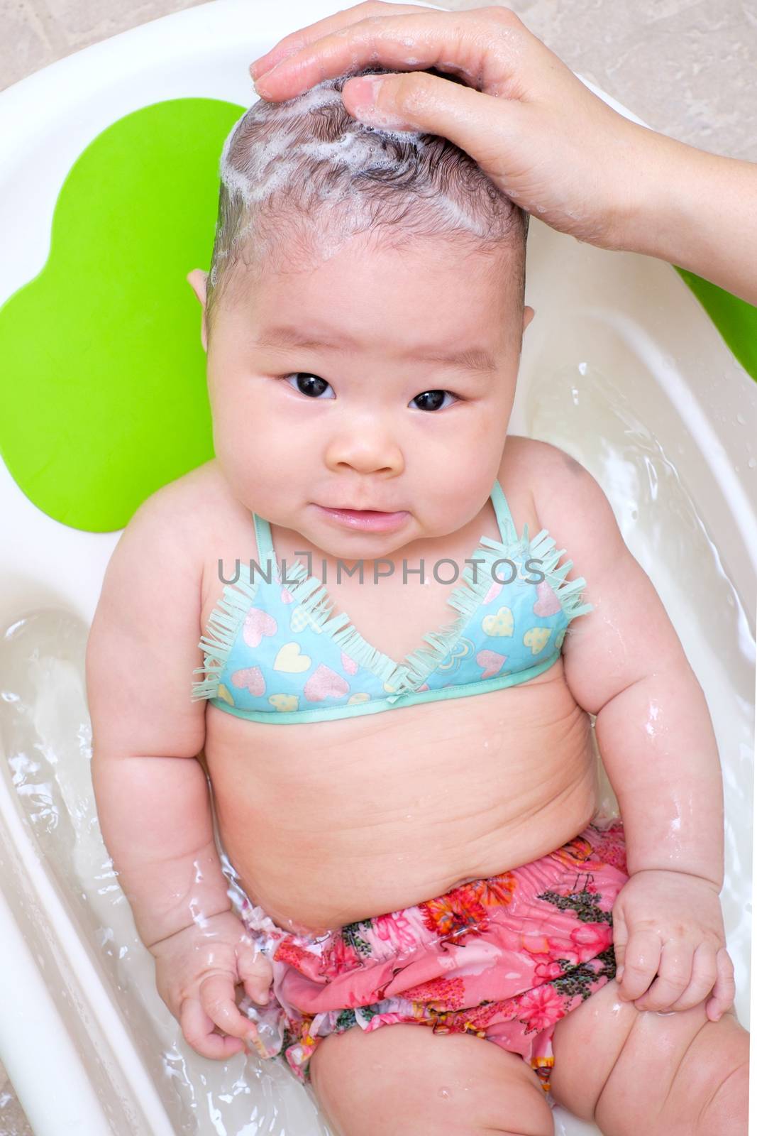 Mom washing baby girl hair by zneb076