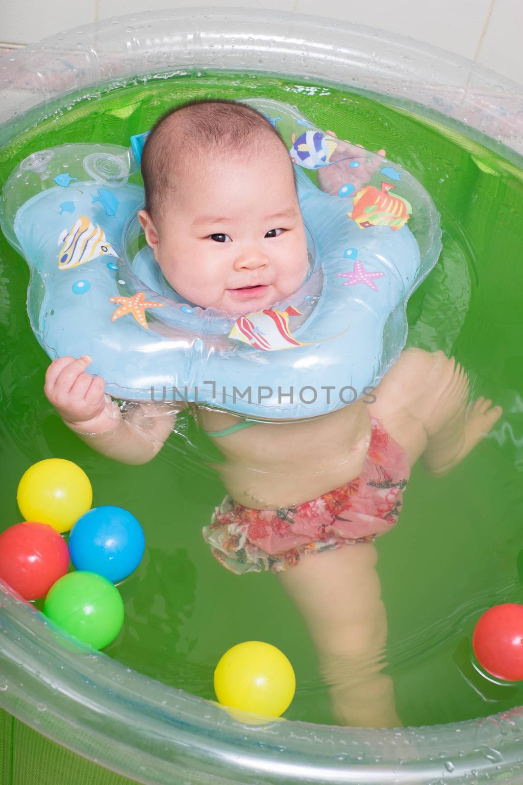 Asian baby girl swimming