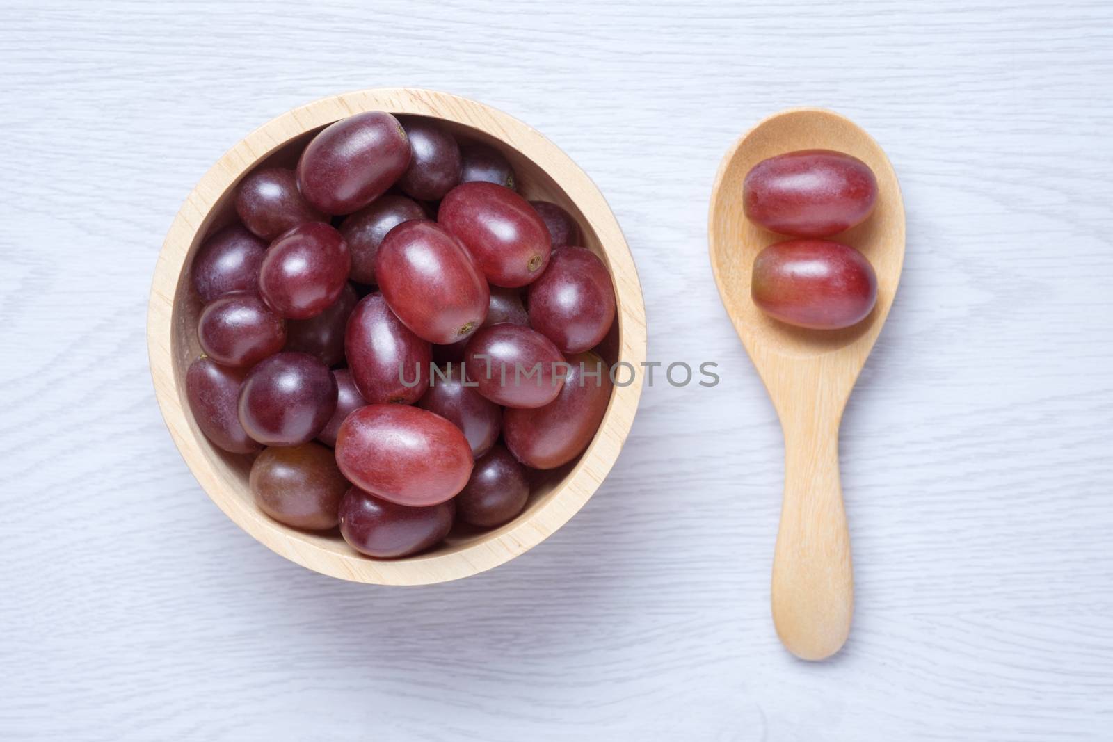 Red grapes in wooden bowl and spoon by zneb076