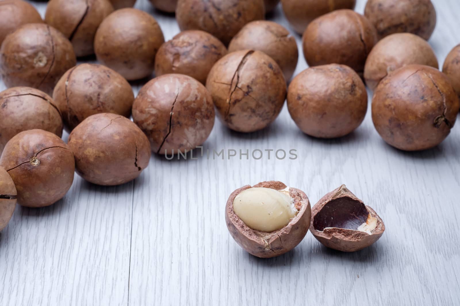 Macadamia on white wooden table by zneb076