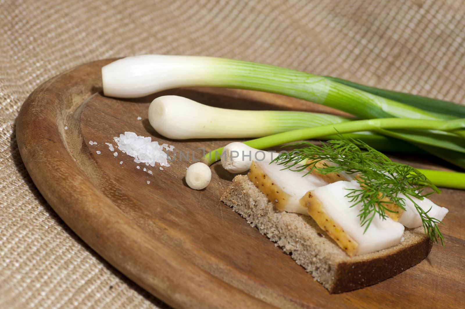 Sandwich with salted lard on rye bread served with green onion and garlic