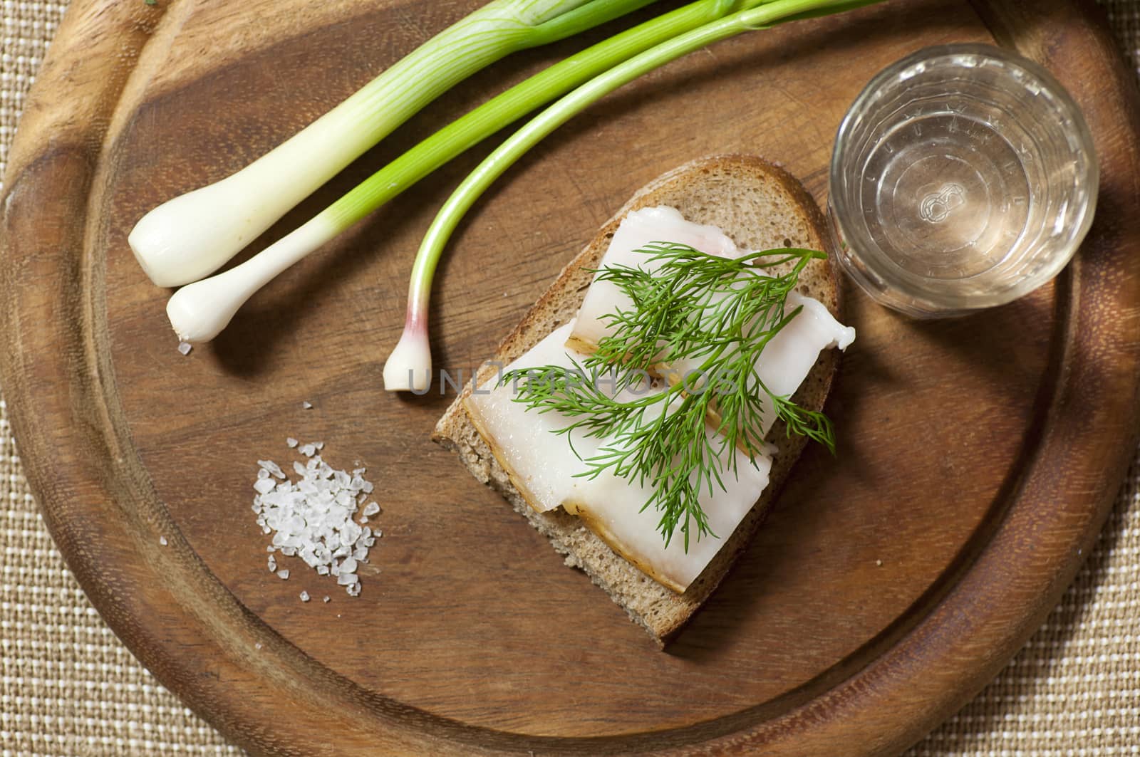 Sandwich with salted lard on rye bread and vodka view from above