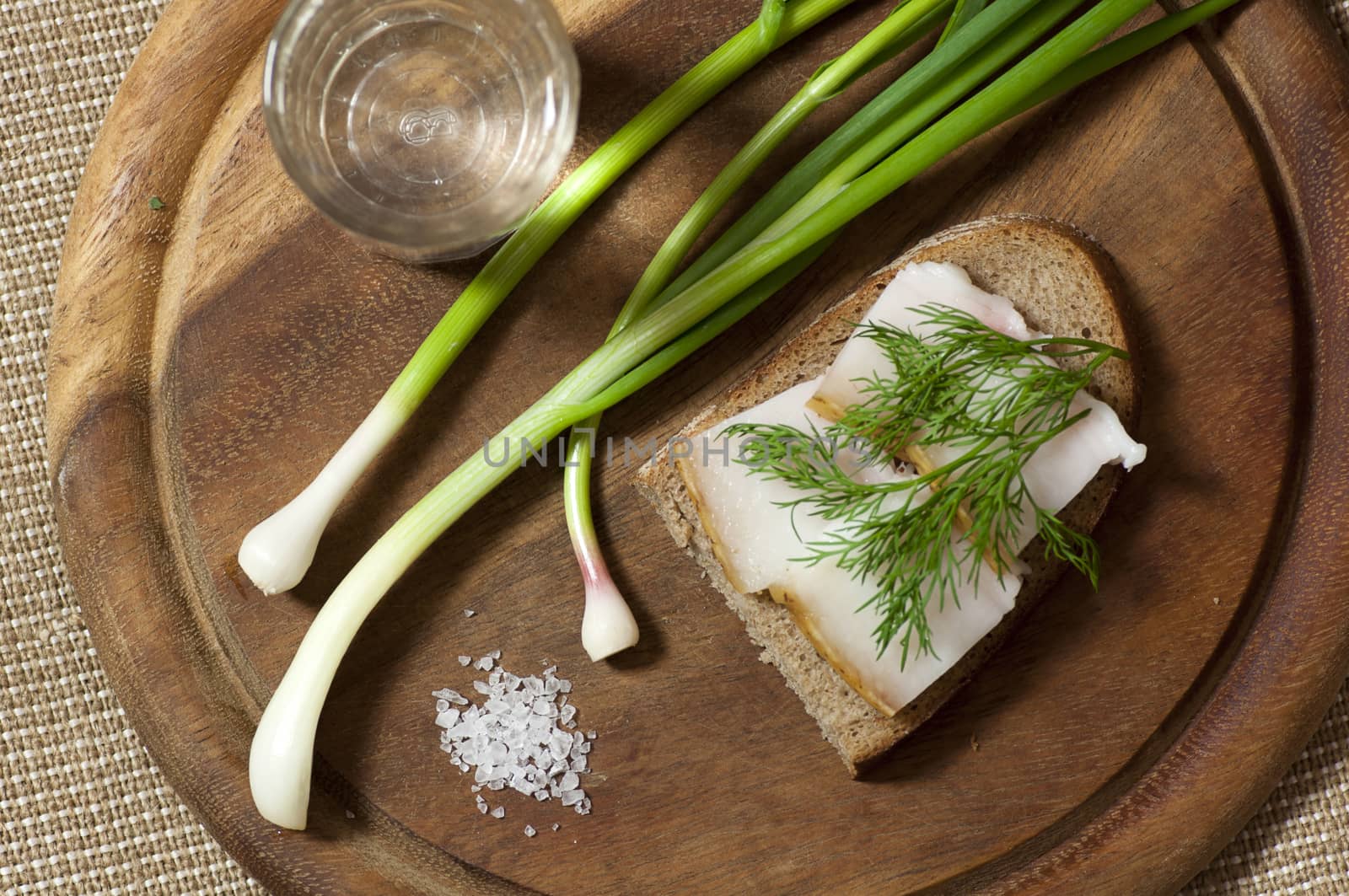 Sandwich with salted lard on rye bread and vodka view from above