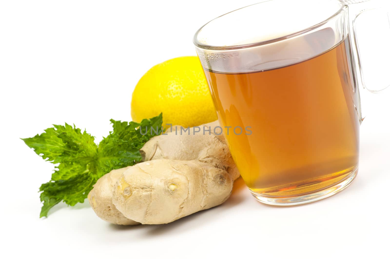 Cup of black tea served with ginger lemon and mint isolated on white