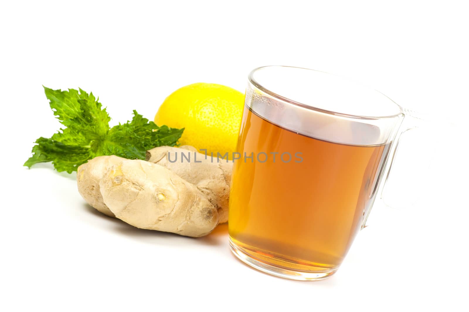 Cup of black tea served with ginger lemon and mint isolated on white