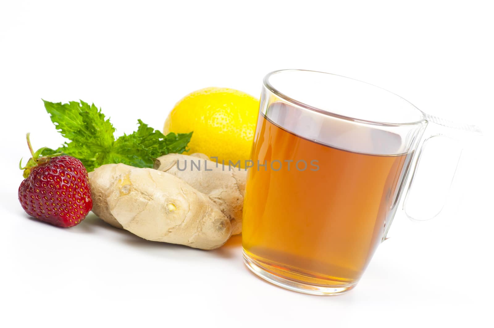 Cup of black tea served with ginger, lemon, strawberry and mint isolated on white