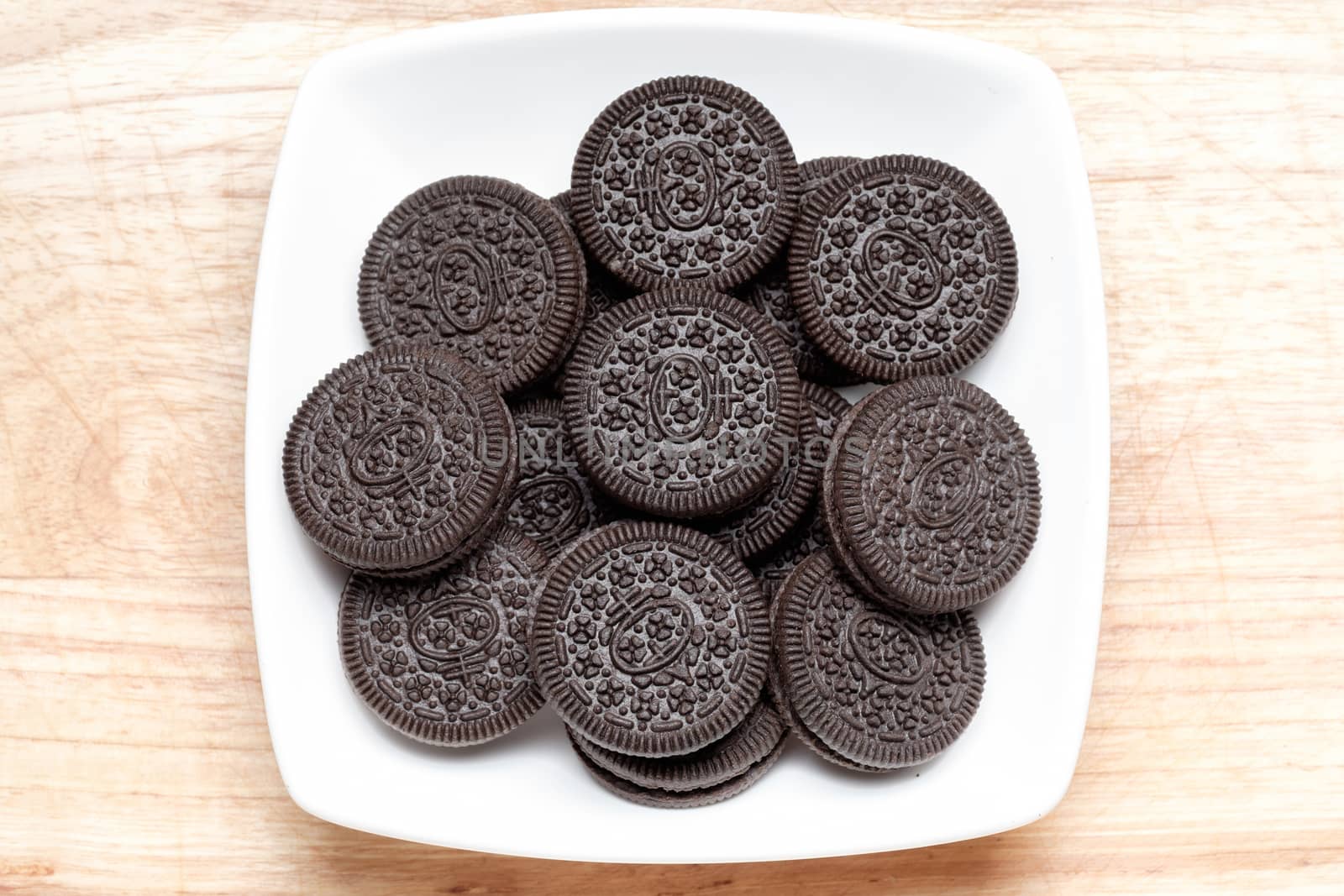 group of black cookie and cream in white ceramic dish. Look very tasty.