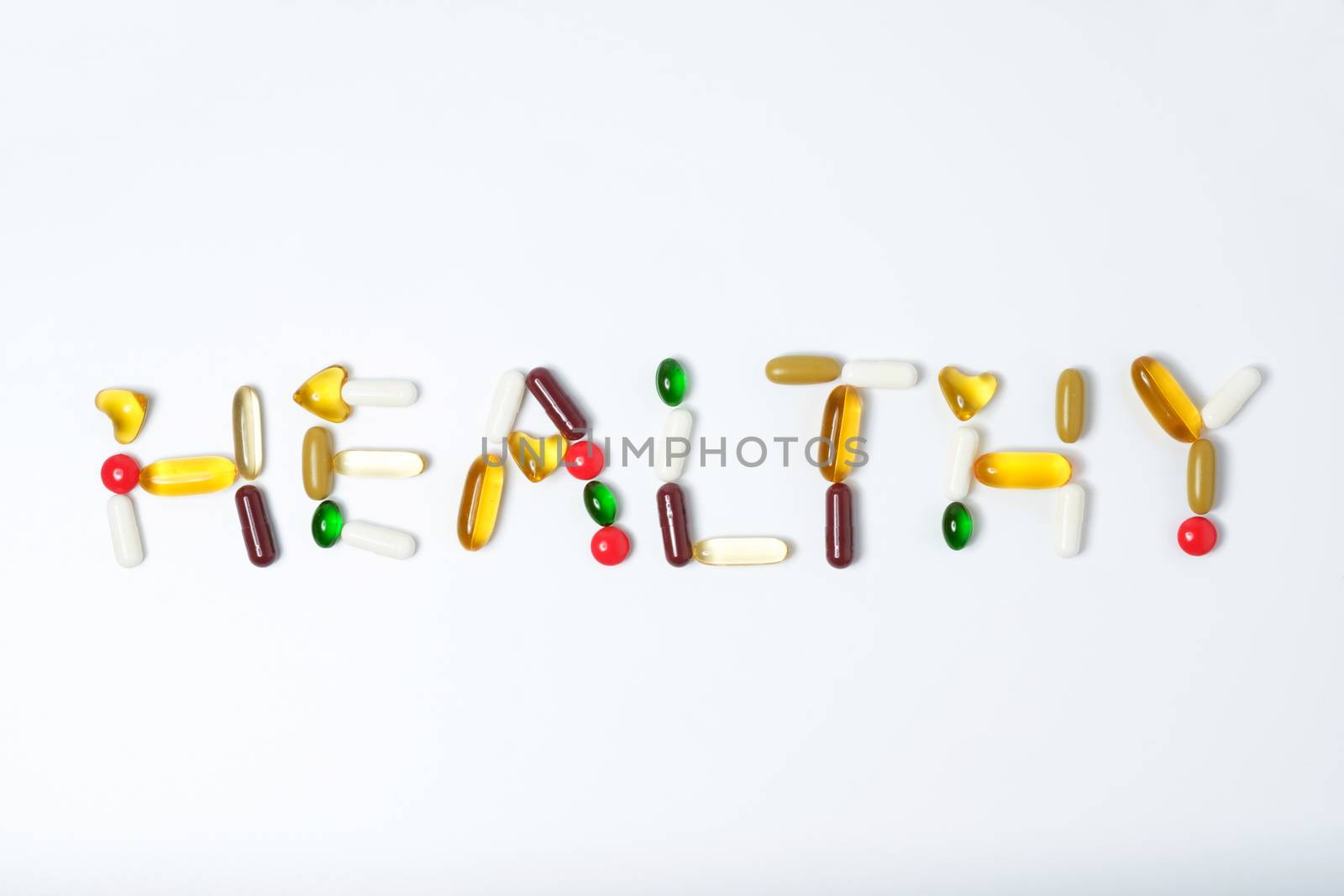 pills of vitamin and medicine on white background by zneb076