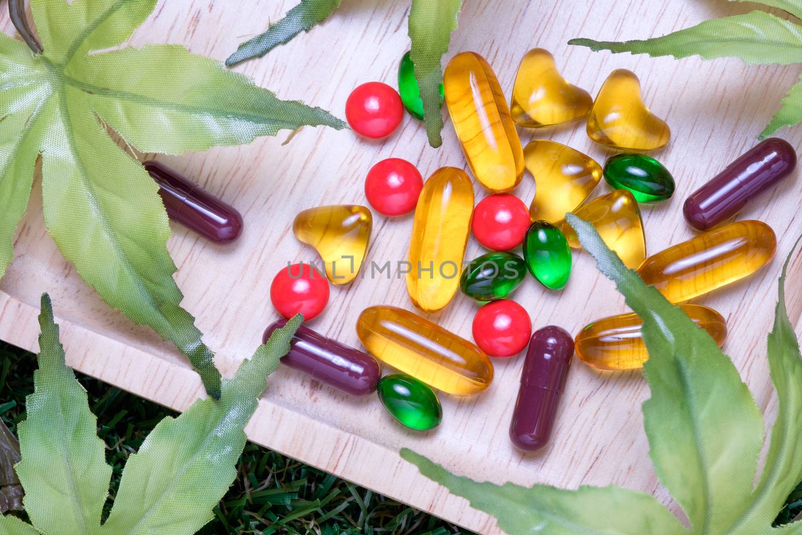 top view of medicine and vitamin on wooden plate