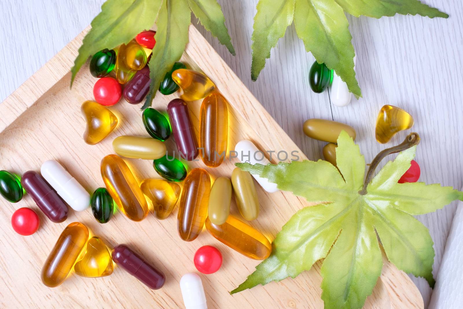 medicine and vitamin on wooden plate by zneb076