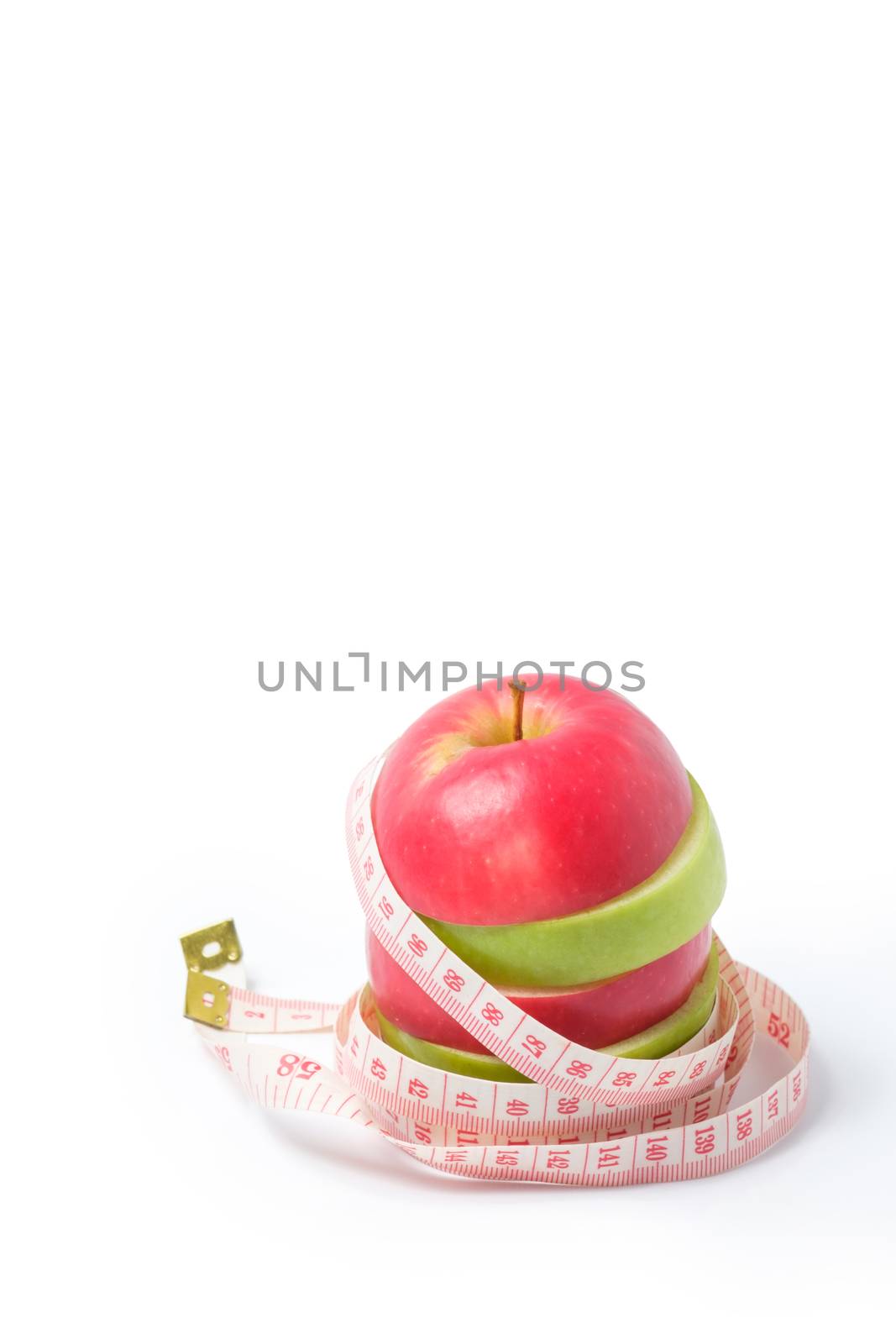 slice red and green apples with waist measure on white background. space for adding your text.
