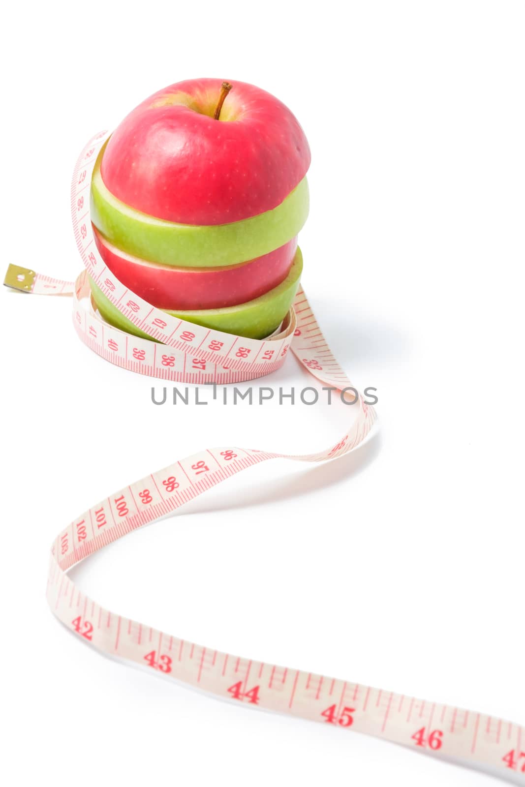 slice red and green apples with waist measure on white background
