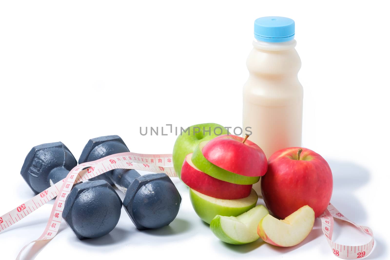 slice red , green apple with dumbbell, waist measure and milk on white background. space for adding your text.
