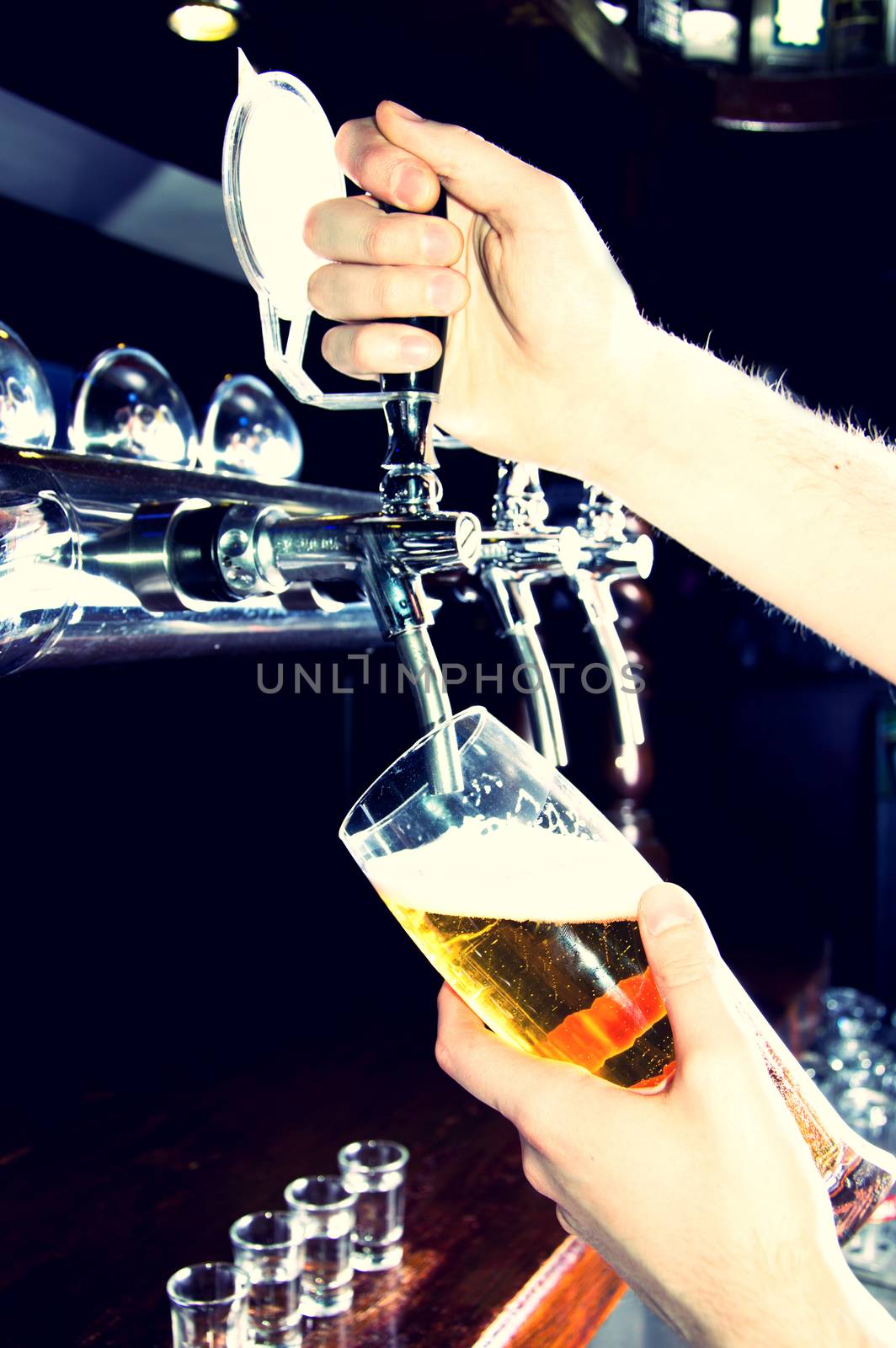Bartender giving the beer from dispenser. Alcohol conceptual image.