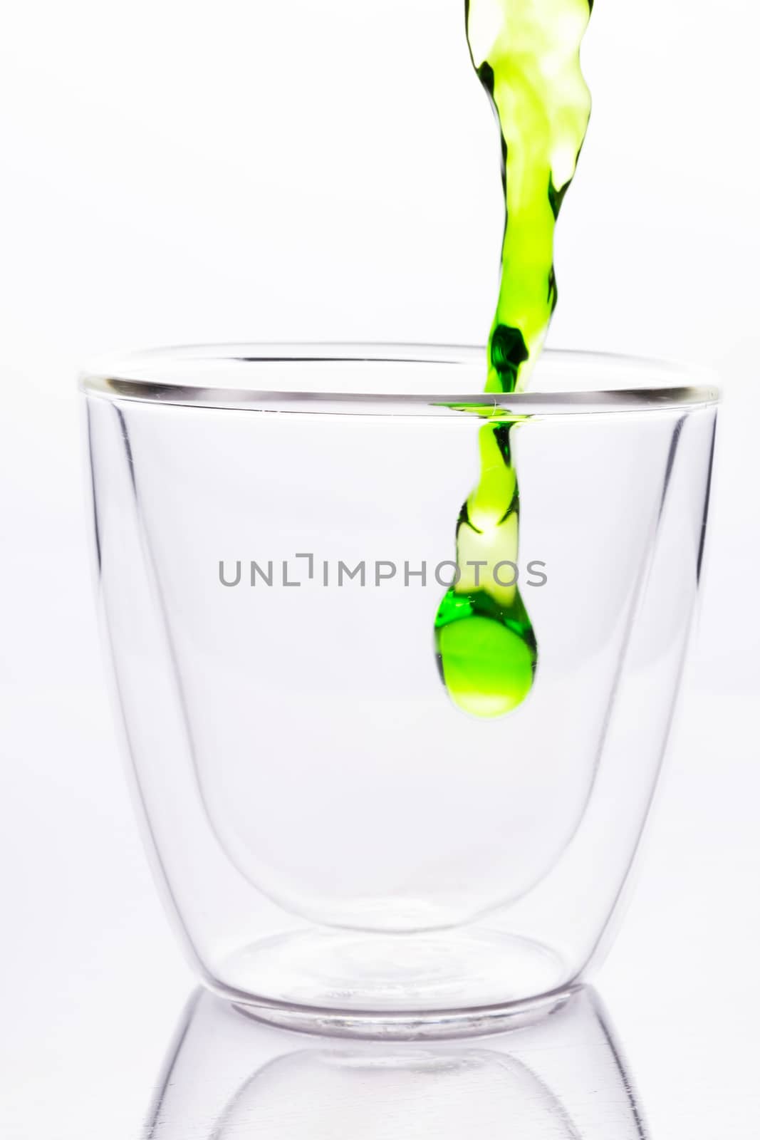 pouring green water in to clear glass by zneb076