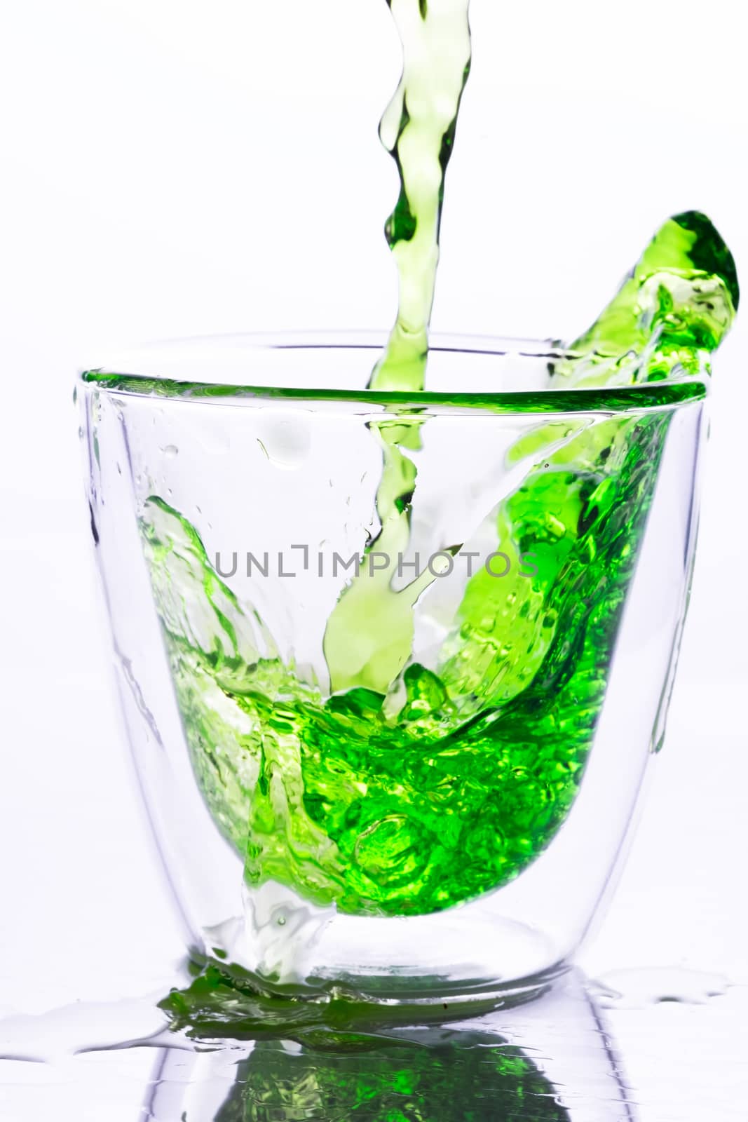 pouring green water in to clear glass by zneb076