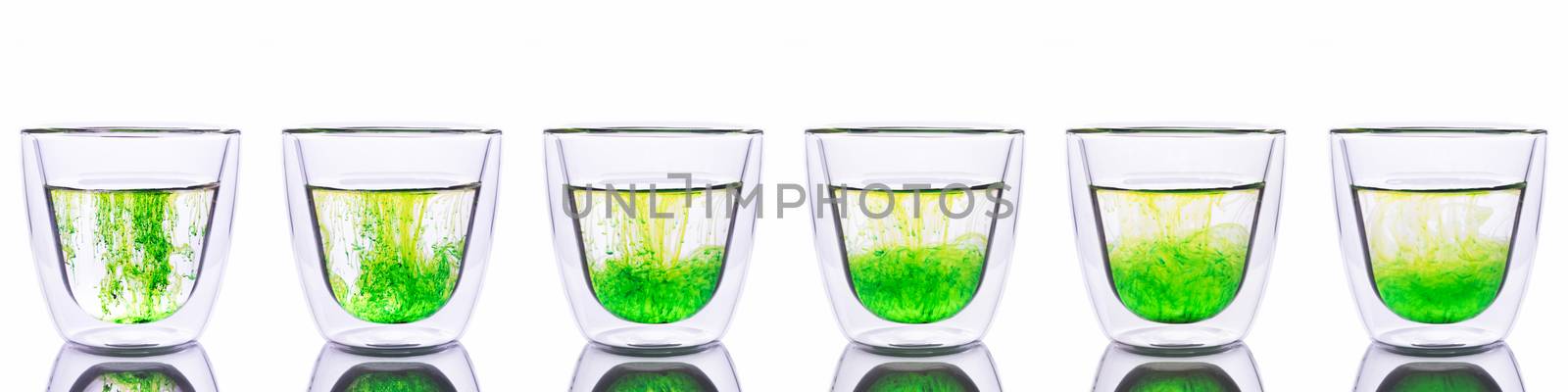Green color spread in glass of water  by zneb076
