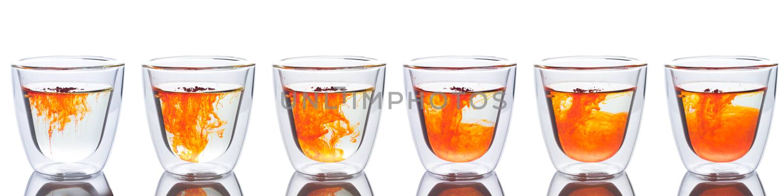 orange color spread in glass of water. Show six step it spread in to water.
