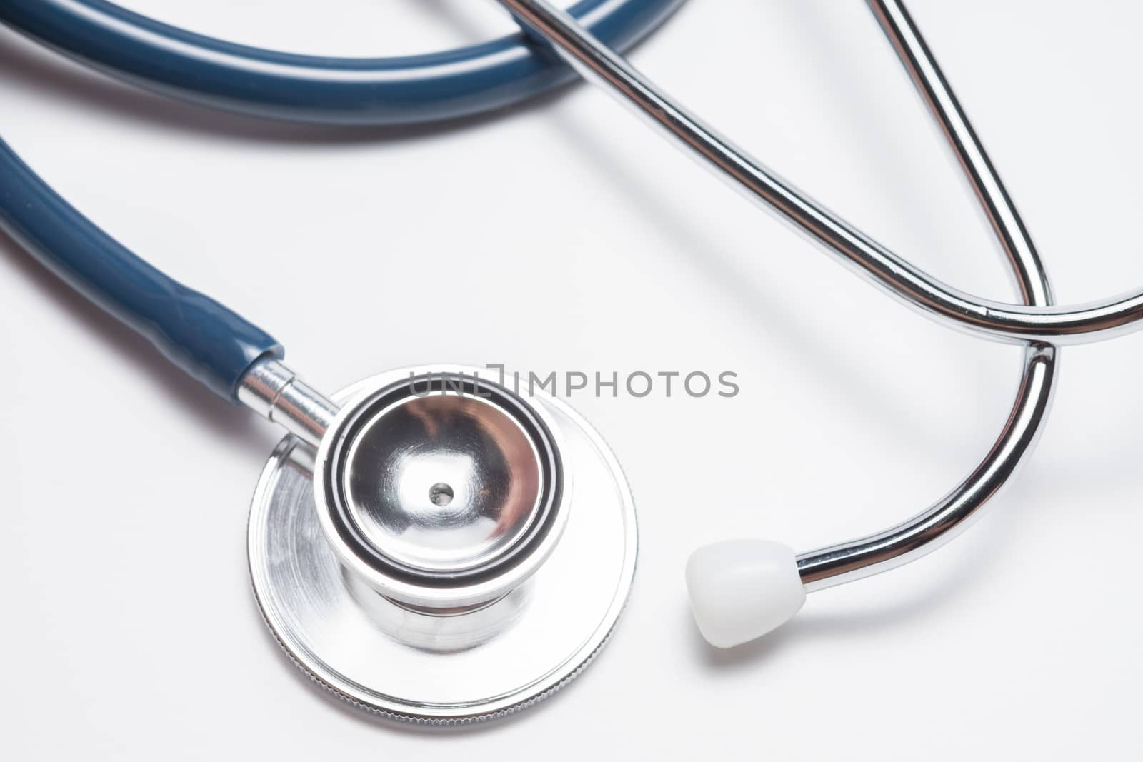Blue stethoscope on white background.
