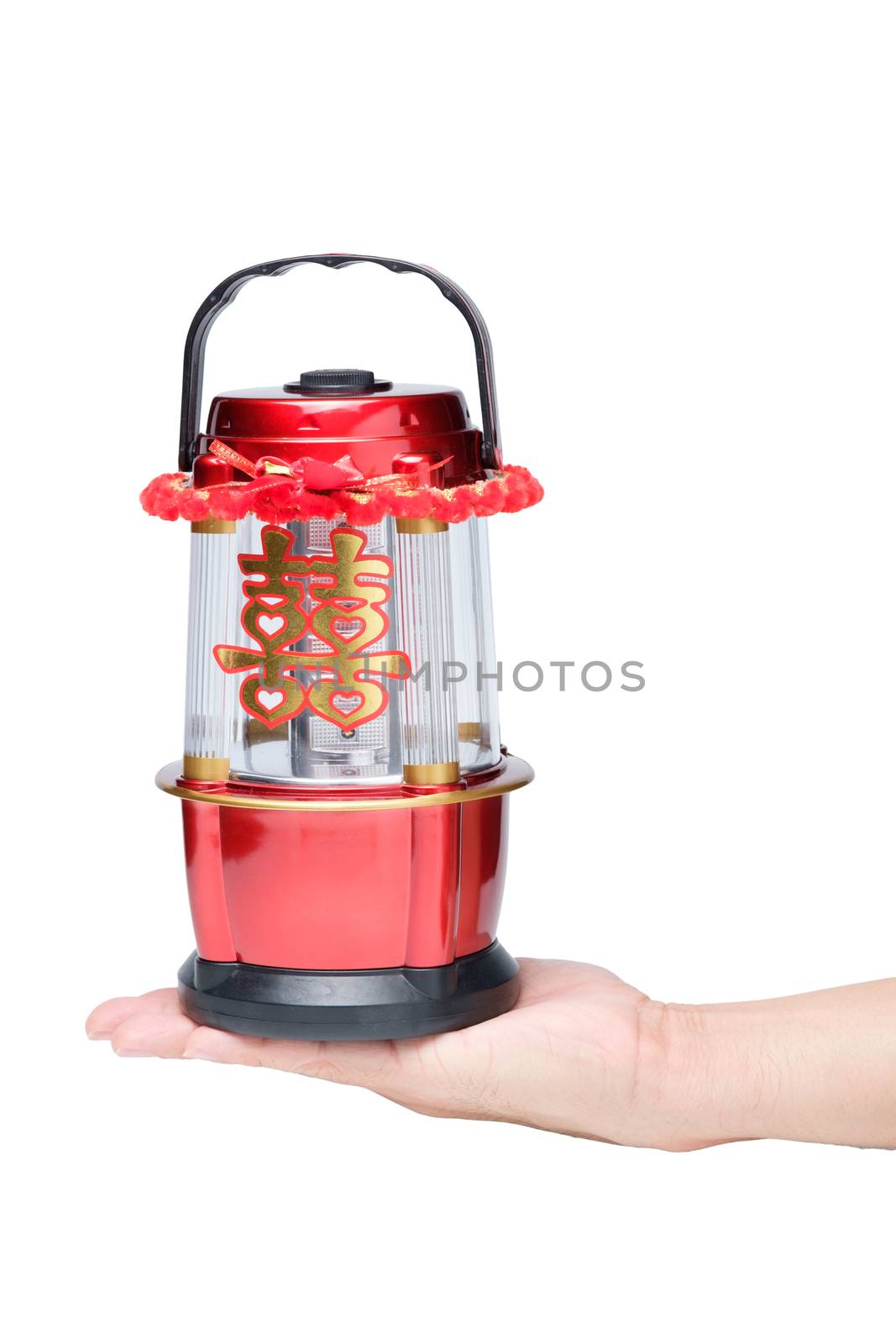 Hand holding Chinese LED lantern lamp with golden Chinese double happiness symbol sign called "shuang xi"