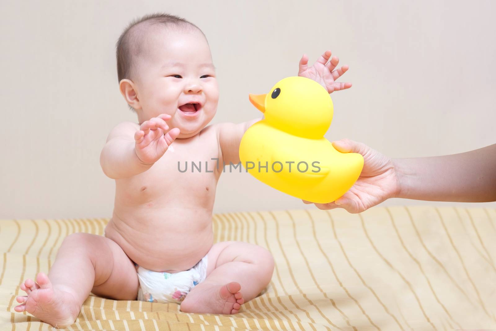 Asian thai baby girl playing with yellow rubber duck by zneb076
