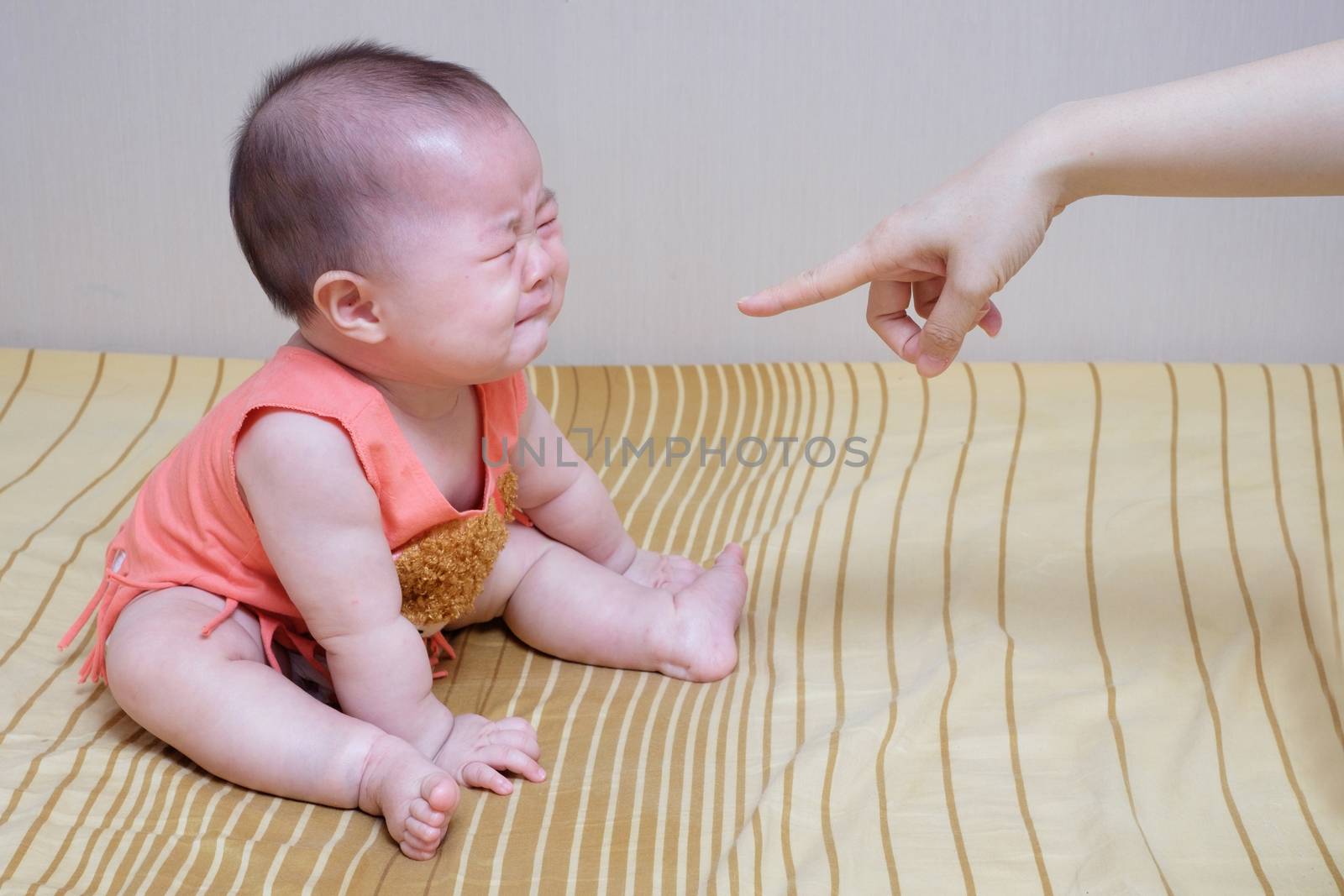 Asian baby crying while mother scolding 
