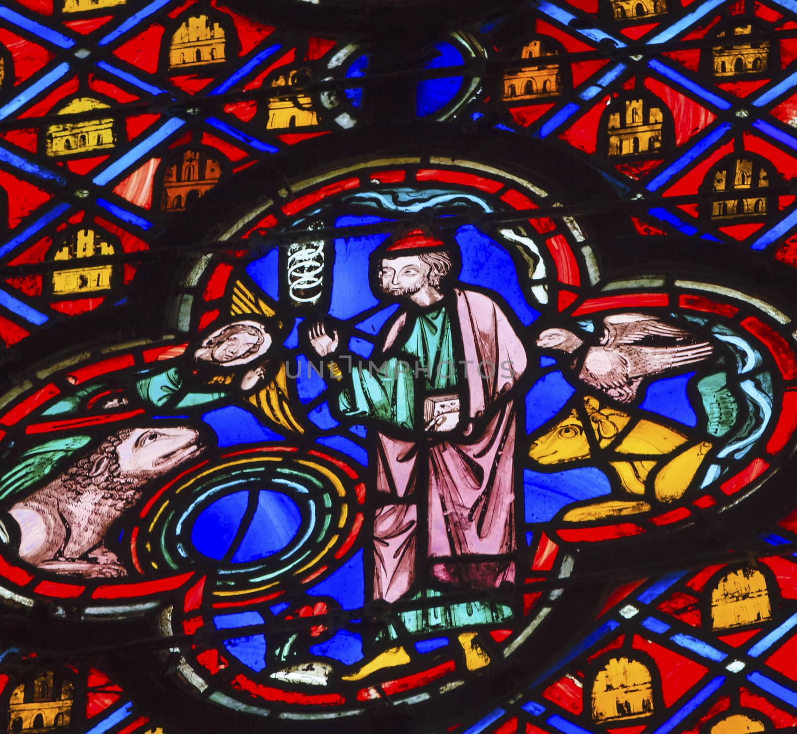 Saint Francis of Assisi Animals Stained Glass Saint Chapelle Paris France.  Francis was 12th Century Century, who worked with animals and the poor.  Saint King Louis 9th created Sainte Chapelle in 1248 to house Christian relics, including Christ's Crown of Thorns.  Stained Glass created in the 13th Century and shows various biblical stories along with stories from 1200s.