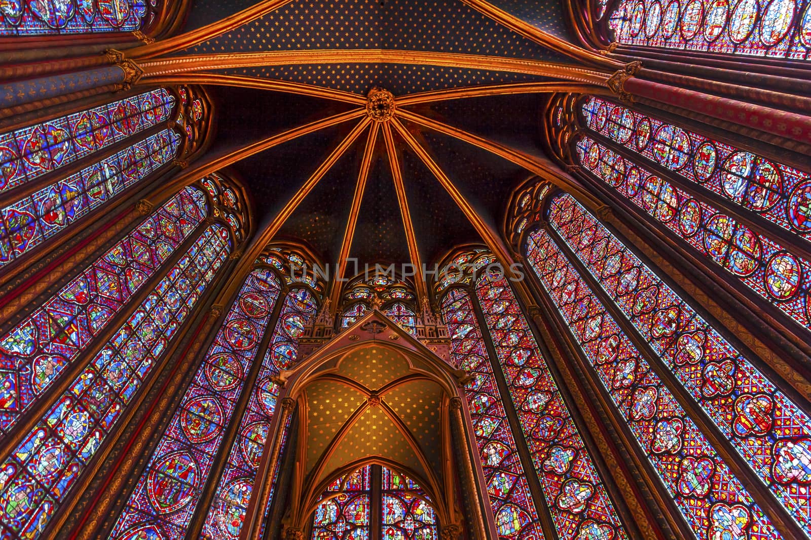 Stained Glass Cathedral Ceiling Saint Chapelle Paris France.  Saint King Louis 9th created Sainte Chappel in 1248 to house Christian relics, including Christ's Crown of Thorns.  Stained Glass created in the 13th Century and shows various biblical stories along wtih stories from 1200s.