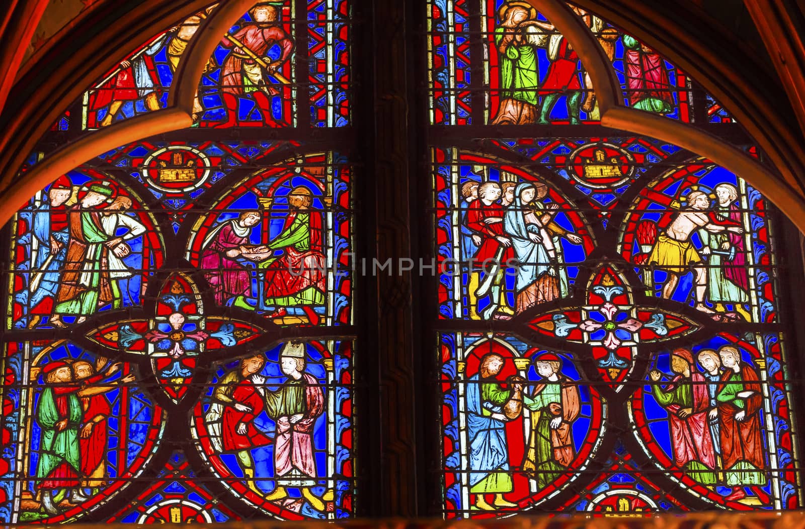 Jesus Crucifixion Story Stained Glass Saint Chapelle Paris France.  Saint King Louis 9th created Sainte Chappel in 1248 to house Christian relics, including Christ's Crown of Thorns.  Stained Glass created in the 13th Century and shows various biblical stories along wtih stories from 1200s.
