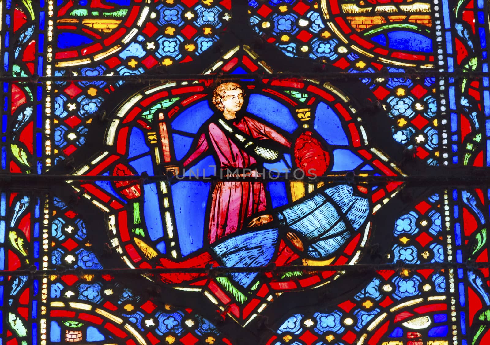Knights Beheading Medieval Life Stained Glass Saint Chapelle Paris France.  Saint King Louis 9th created Sainte Chapelle in 1248 to house Christian relics, including Christ's Crown of Thorns.  Stained Glass created in the 13th Century and shows various biblical stories along with stories from 1200s.