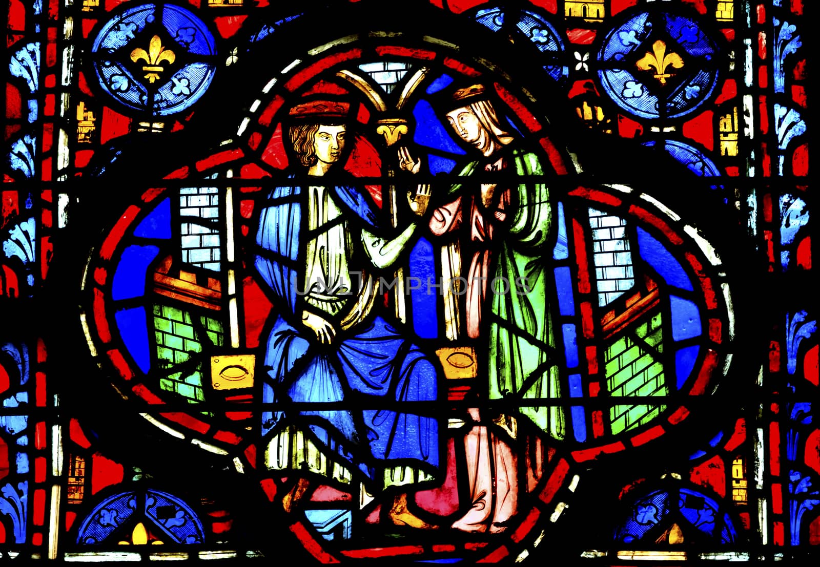 King Queen Medieval Life Stained Glass Saint Chapelle Paris France.  Saint King Louis 9th created Sainte Chapelle in 1248 to house Christian relics, including Christ's Crown of Thorns.  Stained Glass created in the 13th Century and shows various biblical stories along with stories from 1200s.