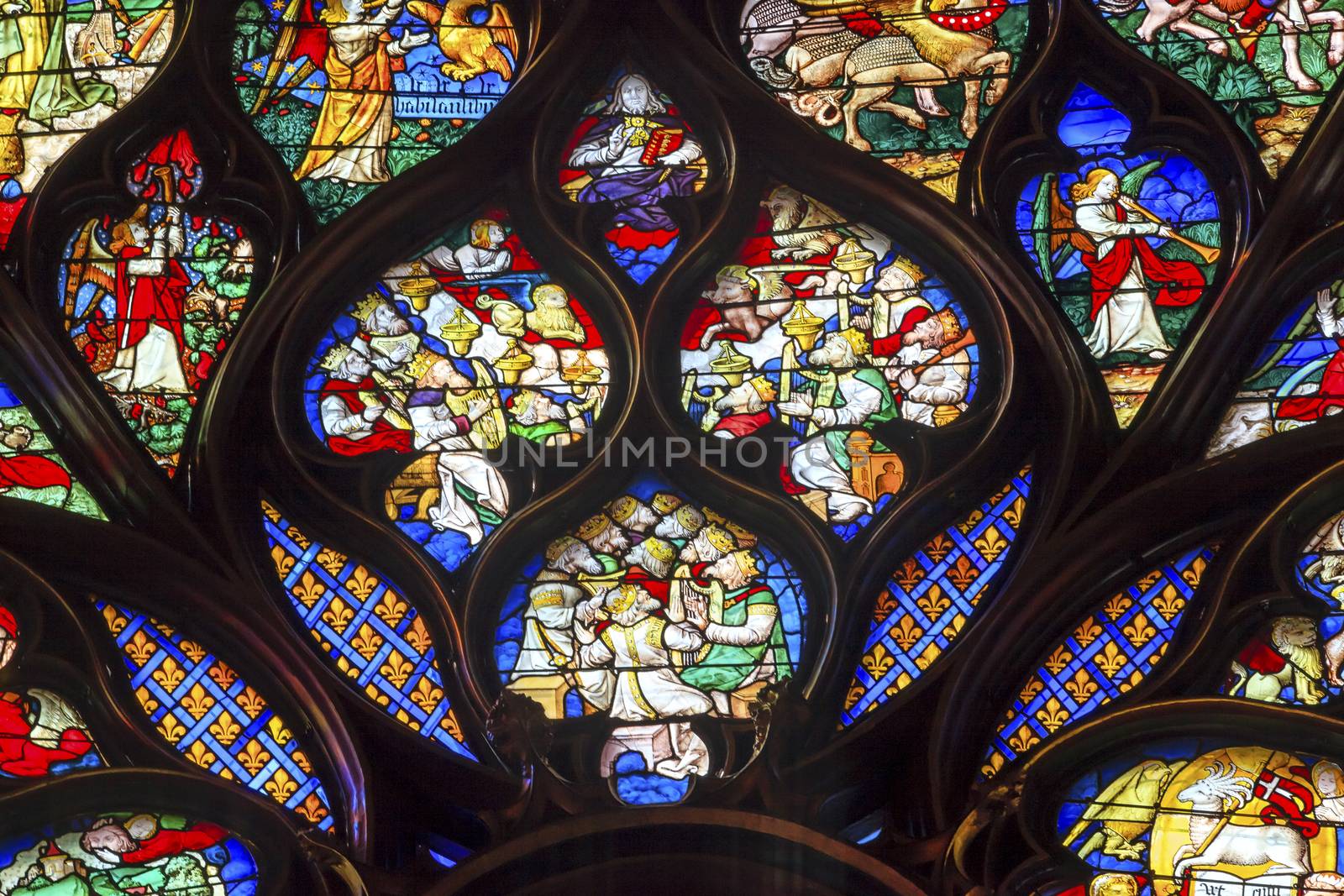 King Louis Advisors Angels Rose Window Stained Glass Saint Chapelle Paris France.  Saint King Louis 9th created Sainte Chappel in 1248 to house Christian relics, including Christ's Crown of Thorns.  Stained Glass created in the 13th Century and shows various biblical stories along wtih stories from 1200s.