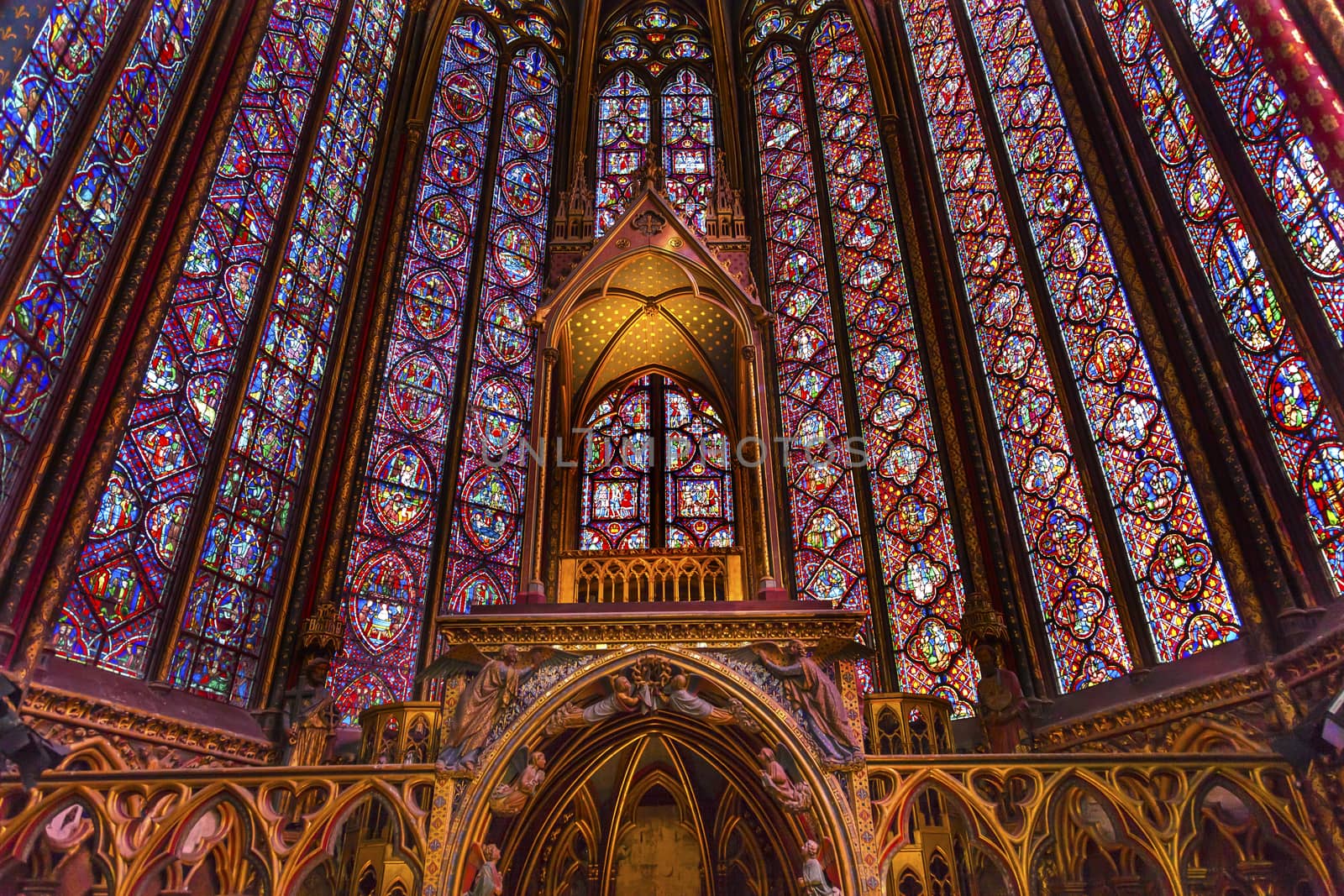 Stained Glass Cathedral Altar Arch Saint Chapelle Paris France.  Saint King Louis 9th created Sainte Chappel in 1248 to house Christian relics, including Christ's Crown of Thorns.  Stained Glass created in the 13th Century and shows various biblical stories along wtih stories from 1200s.