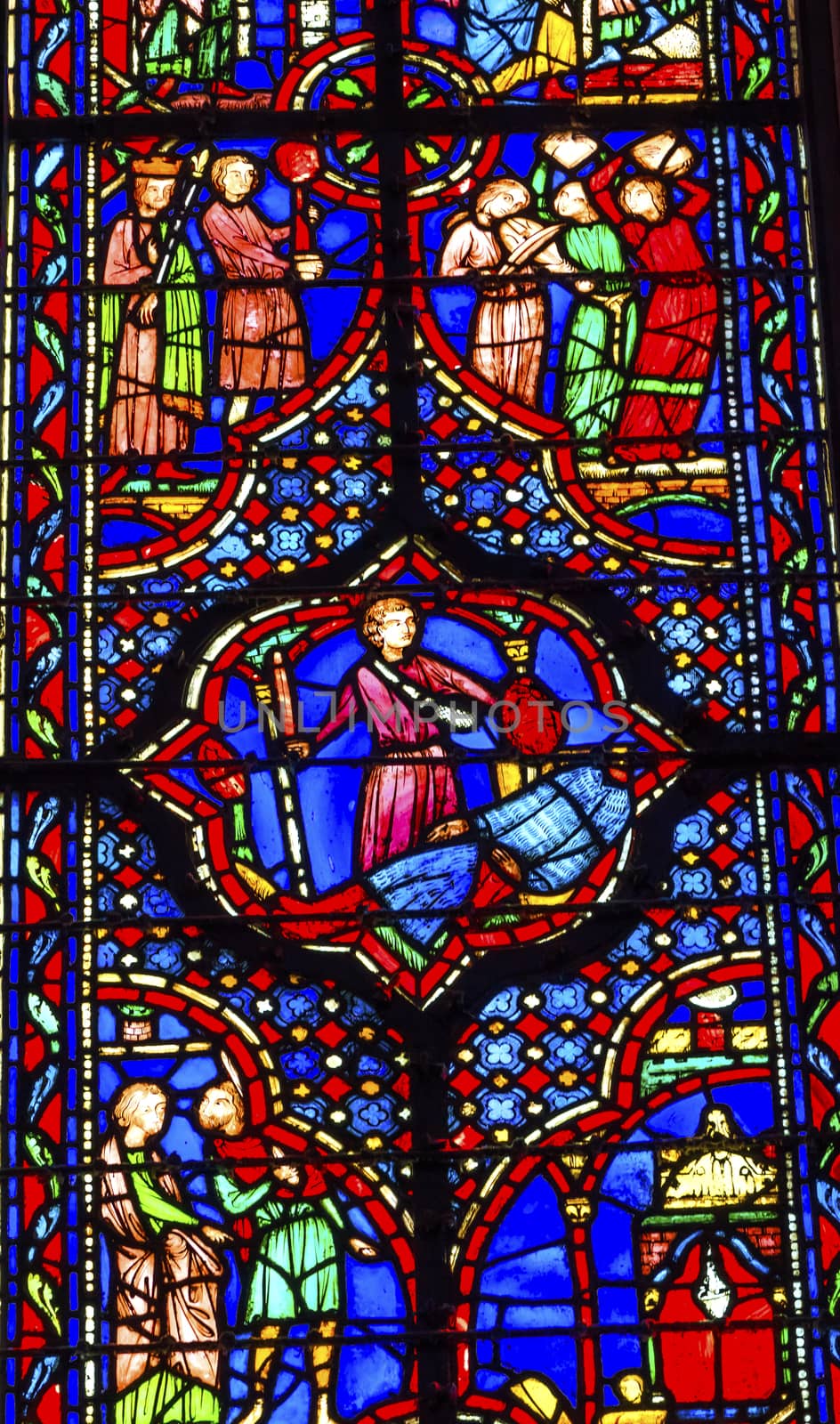 Knights Beheading Medieval Life Stained Glass Saint Chapelle Paris France.  Saint King Louis 9th created Sainte Chapelle in 1248 to house Christian relics, including Christ's Crown of Thorns.  Stained Glass created in the 13th Century and shows various biblical stories along with stories from 1200s.