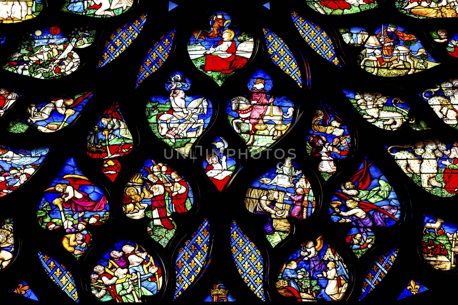 Biblical Medieval Stories Horses Angels  Rose Window Stained Glass Saint Chapelle Paris France.  Saint King Louis 9th created Sainte Chappel in 1248 to house Christian relics, including Christ's Crown of Thorns.  Stained Glass created in the 13th Century and shows various biblical stories along wtih stories from 1200s.