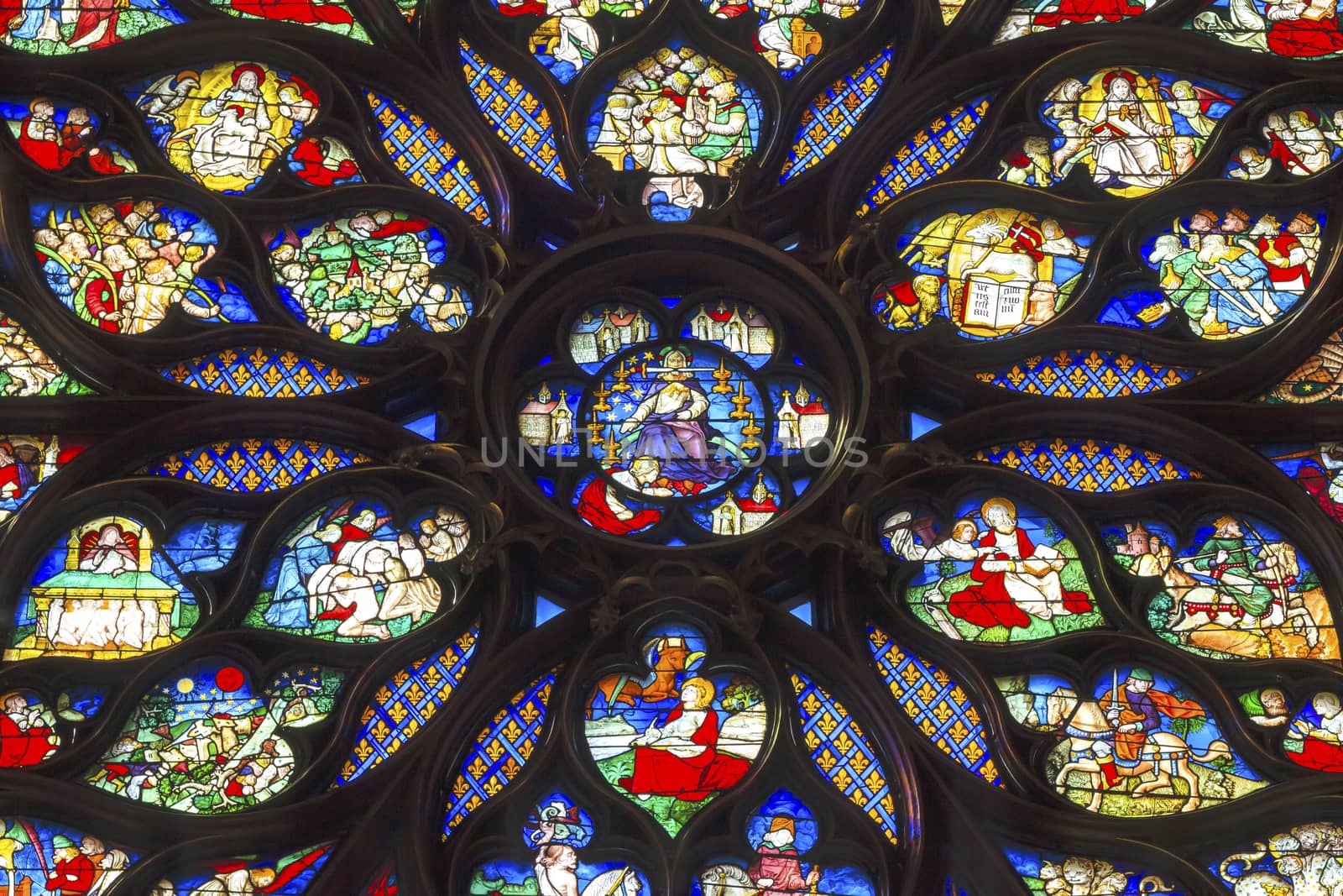 Jesus Christ With Sword Biblical and Medieval Stories Rose Window Stained Glass Saint Chapelle Paris France.  Saint King Louis 9th created Sainte Chappel in 1248 to house Christian relics, including Christ's Crown of Thorns.  Stained Glass created in the 13th Century and shows various biblical stories along wtih stories from 1200s.