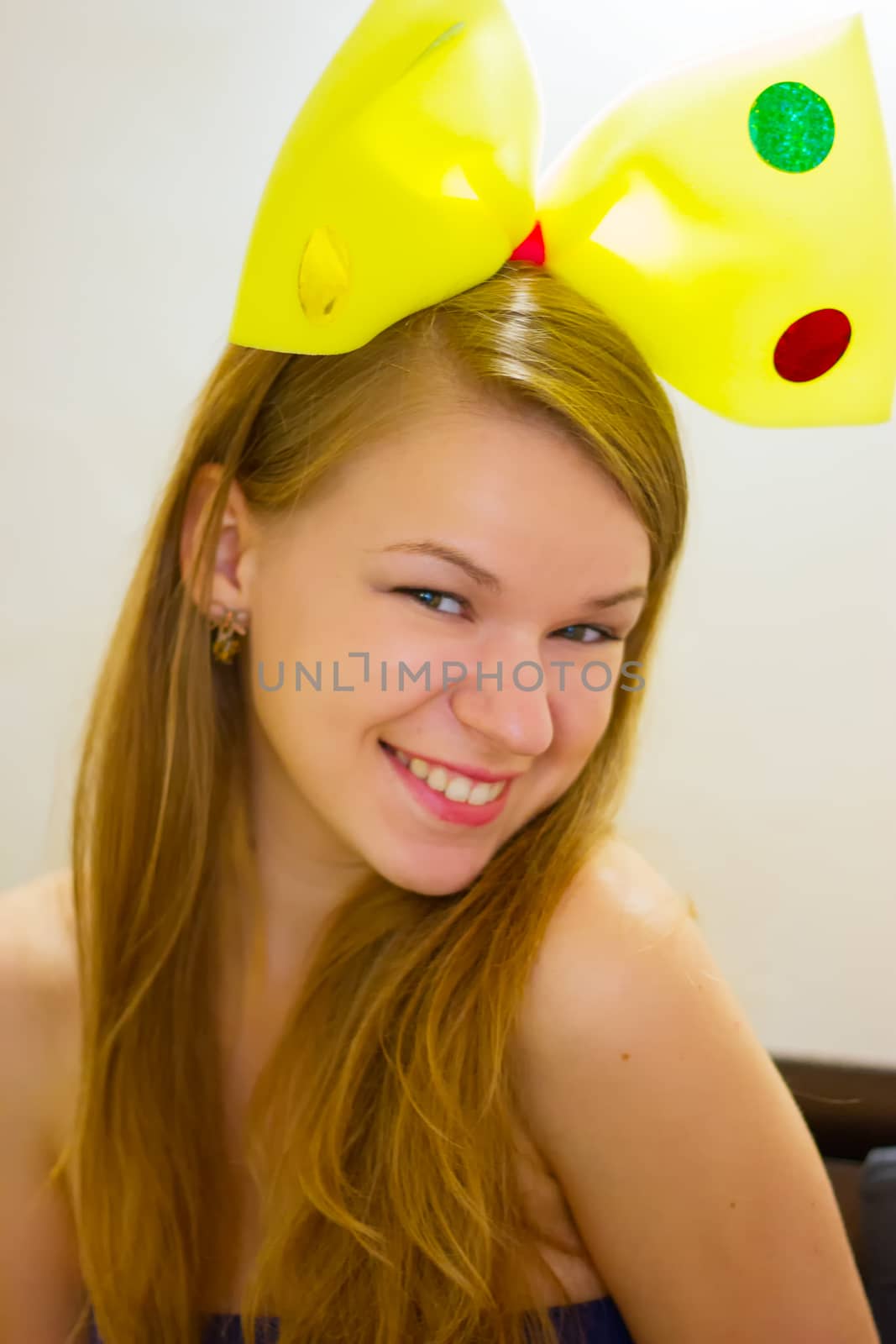 Adult woman of 20 years in children's yellow bow