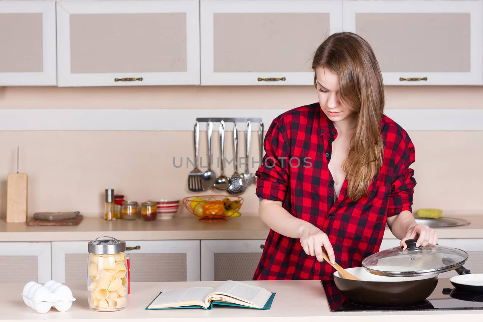 Girl in a red shirt and looking in preparing the book