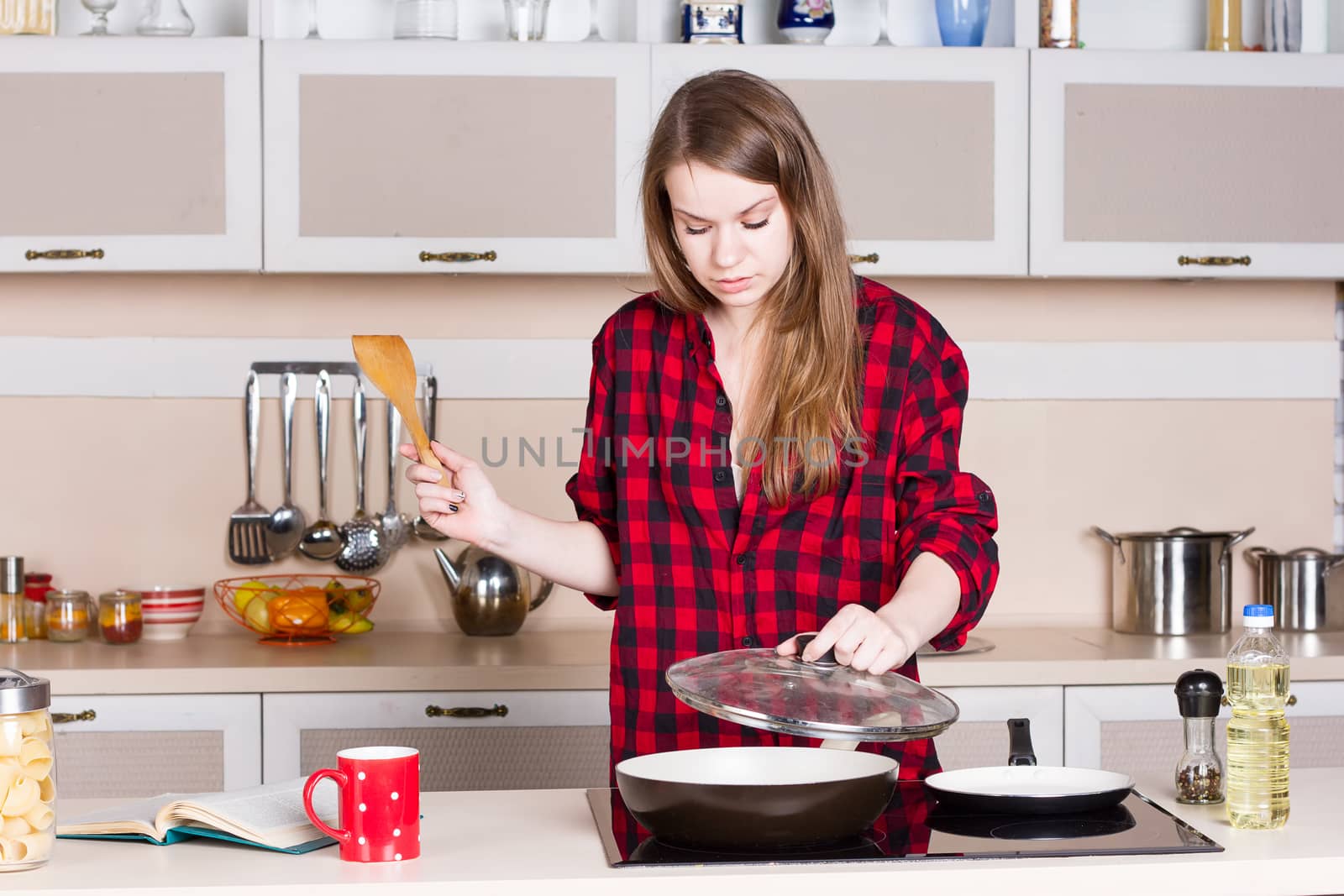 girl in the red shirt is preparing in the kitchen