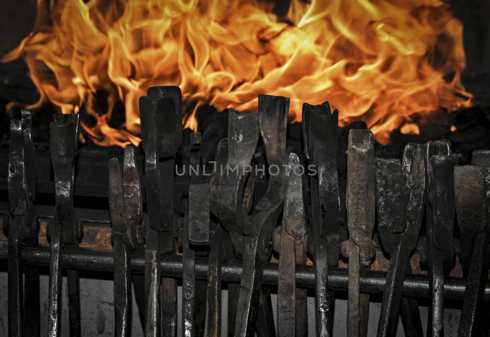 smith tongs in the background of forging fire of an outbreak