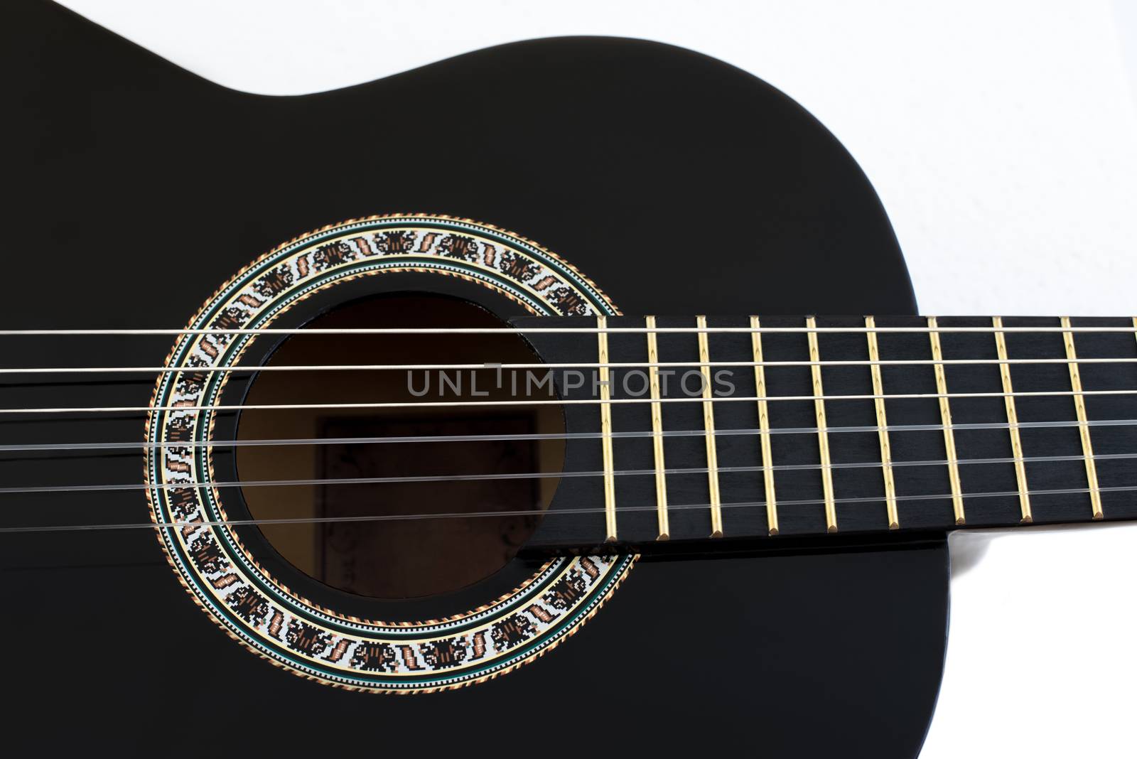 Detail of Black Wooden Classical Acoustic Guitar Isolated on a White Background