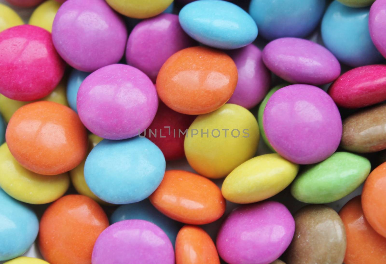 Colored candy smarties texture pattern background by cheekylorns